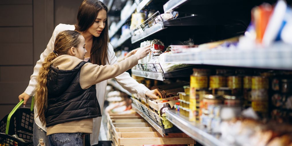Mother with daughter shopping at grocery store