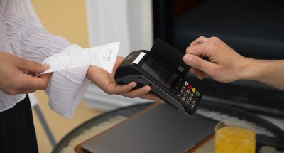 side-view-customer-paying-with-nfc-device