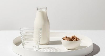 front-view-tray-with-milk-bottle-walnuts_23-2148667695