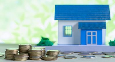 model-house-with-coins-wooden-table_1150-12785