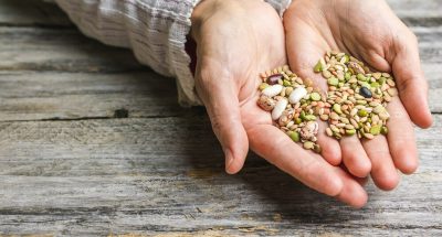 closeup-shot-female-hands-holding-mixed-beans_181624-25286