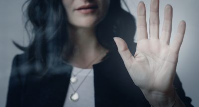 Woman with a beautiful hand touching the window