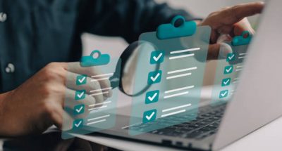 Businessman use magnifying glass with a checklist on clipboard paper. Successfully complete business assignments.