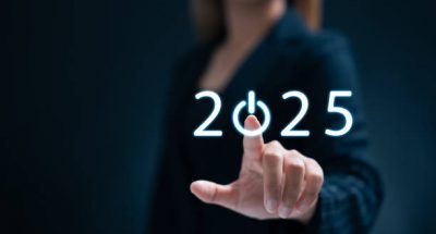 A businesswoman taps a start button for New Year 2025, sets goals, and develops strategies to achieve better results in the future.