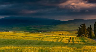 A beautiful scenery of a field surrounded by hills in the countryside